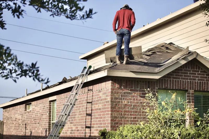 Professional roofer working on a residential roof in Morrison